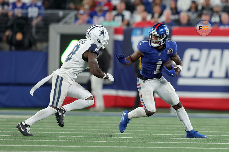 Sep 26, 2024; East Rutherford, New Jersey, USA; New York Giants wide receiver Malik Nabers (1) runs with the ball against Dallas Cowboys cornerback Jourdan Lewis (2) during the fourth quarter at MetLife Stadium. Credit: Brad Penner-Imagn Images