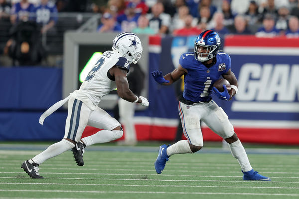 Sep 26, 2024; East Rutherford, New Jersey, USA; New York Giants wide receiver Malik Nabers (1) runs with the ball against Dallas Cowboys cornerback Jourdan Lewis (2) during the fourth quarter at MetLife Stadium. Mandatory Credit: Brad Penner-Imagn Images