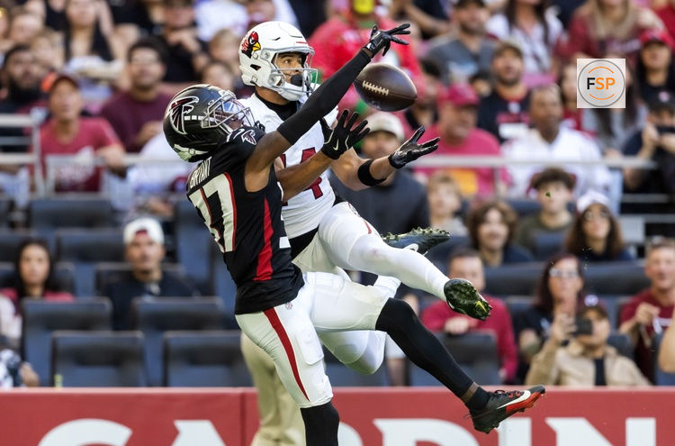Dec 21, 2025; Glendale, Arizona, USA;  Arizona Cardinals wide receiver Michael Wilson (14) makes the touchdown catch as Atlanta Falcons cornerback Cobee Bryant (37) defends during the first half at State Farm Stadium. Credit: Mark J. Rebilas-Imagn Im