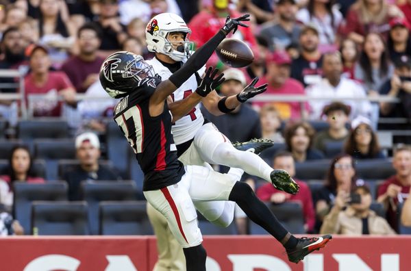 Dec 21, 2025; Glendale, Arizona, USA;  Arizona Cardinals wide receiver Michael Wilson (14) makes the touchdown catch as Atlanta Falcons cornerback Cobee Bryant (37) defends during the first half at State Farm Stadium. Mandatory Credit: Mark J. Rebilas-Imagn Im