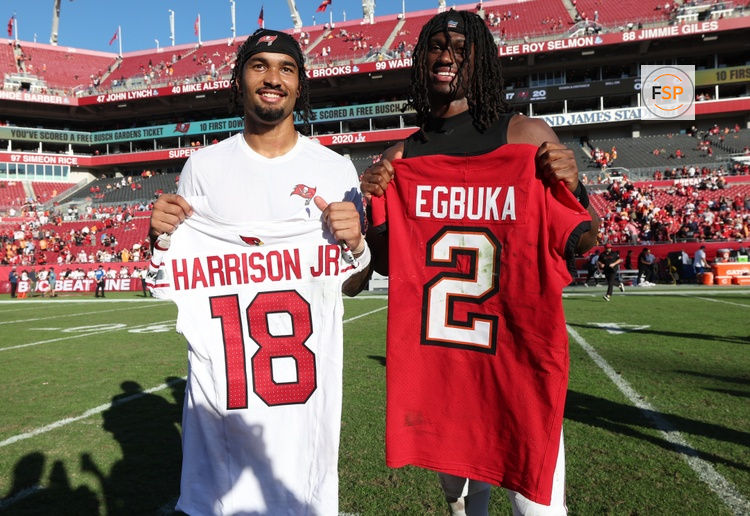 Nov 30, 2025; Tampa, Florida, USA; Tampa Bay Buccaneers wide receiver Emeka Egbuka (2) and Arizona Cardinals wide receiver Marvin Harrison Jr. (18) exchange jerseys after a game at Raymond James Stadium. Credit: Nathan Ray Seebeck-Imagn Images
