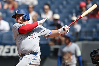 Jun 26, 2025; Cleveland, Ohio, USA; Toronto Blue Jays pinch hitter Alejandro Kirk (30) hits an RBI single during the ninth inning against the Cleveland Guardians at Progressive Field. Mandatory Credit: Ken Blaze-Imagn Images