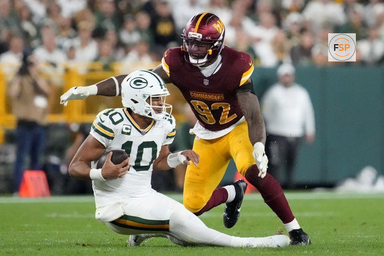 Sep 11, 2025; Green Bay, Wisconsin, USA;  Washington Commanders defensive end Dorance Armstrong (92) sacks Green Bay Packers quarterback Jordan Love (10) in the fourth quarter at Lambeau Field. Credit: Jeff Hanisch-Imagn Images
