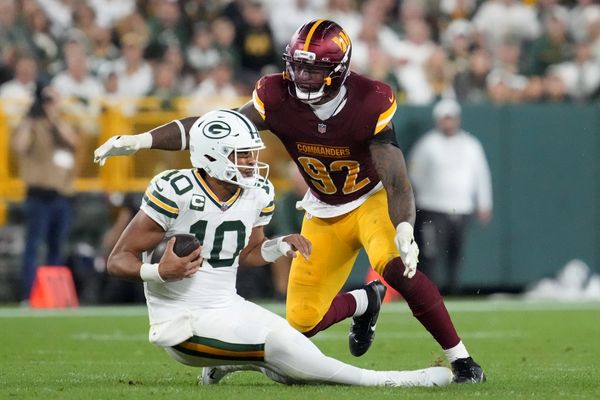 Sep 11, 2025; Green Bay, Wisconsin, USA;  Washington Commanders defensive end Dorance Armstrong (92) sacks Green Bay Packers quarterback Jordan Love (10) in the fourth quarter at Lambeau Field. Mandatory Credit: Jeff Hanisch-Imagn Images