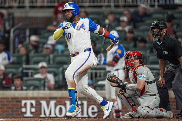 Jun 28, 2025; Cumberland, Georgia, USA; Atlanta Braves designated hitter Marcell Ozuna (20) singles against the Philadelphia Phillies during the seventh inning at Truist Park. Mandatory Credit: Dale Zanine-Imagn Images
