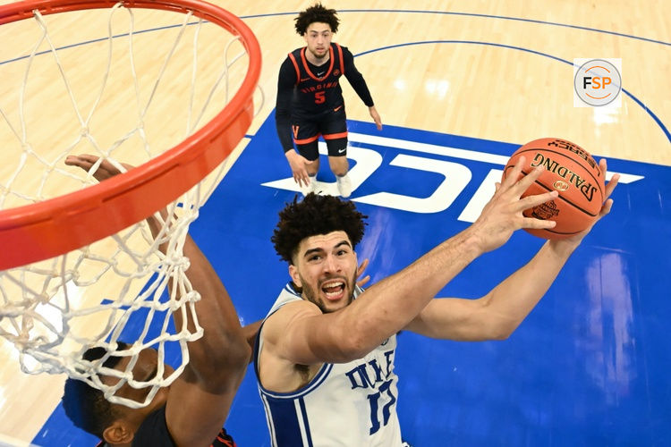 Mar 14, 2026; Charlotte, NC, USA; Duke Blue Devils forward Cameron Boozer (12) goes to the basket against Virginia Cavaliers center Ugonna Onyenso (33) during the men's ACC Conference Tournament Championship at Spectrum Center. Credit: Bob Donnan-Imagn Images