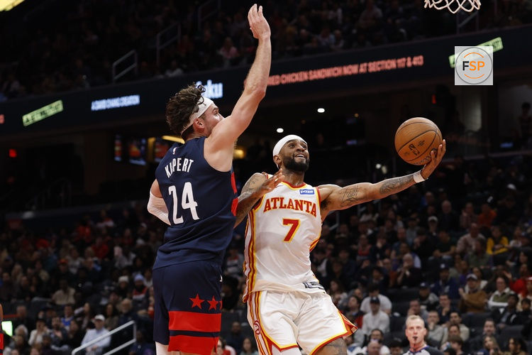 Nov 25, 2025; Washington, District of Columbia, USA; Washington Wizards forward Corey Kispert (24) prepares to block shot by Atlanta Hawks guard Nickeil Alexander-Walker (7) in the first half at Capital One Arena. Credit: Geoff Burke-Imagn Images
