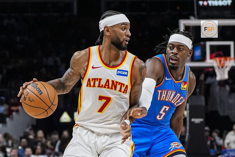 Oct 25, 2025; Atlanta, Georgia, USA; Atlanta Hawks guard Nickeil Alexander-Walker (7) is defended by Oklahoma City Thunder guard Luguentz Dort (5) during the first half at State Farm Arena. Credit: Dale Zanine-Imagn Images