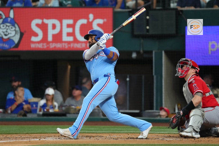 Aug 23, 2026; Arlington, Texas, USA;  Texas Rangers center fielder Ezequiel Duran (20) follows through on his solo home run against the Los Angeles Angels during the second inning at Globe Life Field.  Credit: Jim Cowsert-Imagn Images