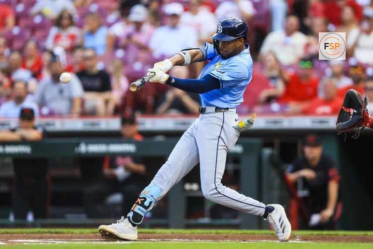 Jul 25, 2025; Cincinnati, Ohio, USA; Tampa Bay Rays outfielder Chandler Simpson (14) hits a double in the first inning against the Cincinnati Reds at Great American Ball Park. Credit: Katie Stratman-Imagn Images