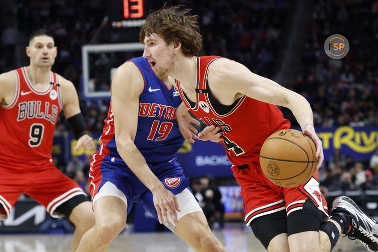 Feb 2, 2025; Detroit, Michigan, USA; Chicago Bulls forward Matas Buzelis (14) dribbles on Detroit Pistons forward Simone Fontecchio (19) in the first half at Little Caesars Arena. Credit: Rick Osentoski-Imagn Images