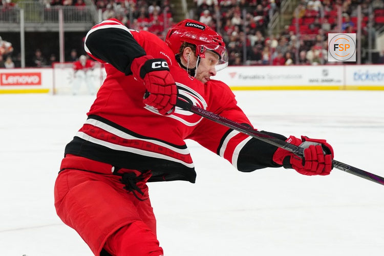 Mar 2, 2025; Raleigh, North Carolina, USA; Carolina Hurricanes right wing Mikko Rantanen (96) takes a shot against the Calgary Flames during the first period at Lenovo Center. Credit: James Guillory-Imagn Images