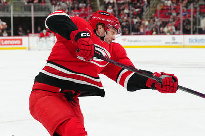 Mar 2, 2025; Raleigh, North Carolina, USA; Carolina Hurricanes right wing Mikko Rantanen (96) takes a shot against the Calgary Flames during the first period at Lenovo Center. Mandatory Credit: James Guillory-Imagn Images