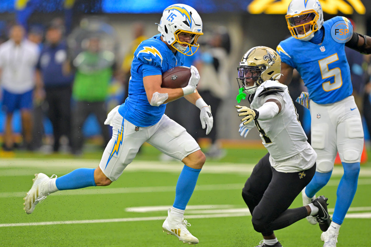 Oct 27, 2024; Inglewood, California, USA; Los Angeles Chargers wide receiver Ladd McConkey (15) catches a pass and runs past New Orleans Saints cornerback Kool-Aid McKinstry (14) for a touchdown in the second half at SoFi Stadium. Credit: Jayne Kamin-Oncea-Imagn Images