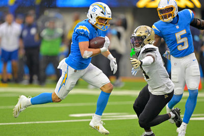 Oct 27, 2024; Inglewood, California, USA; Los Angeles Chargers wide receiver Ladd McConkey (15) catches a pass and runs past New Orleans Saints cornerback Kool-Aid McKinstry (14) for a touchdown in the second half at SoFi Stadium. Mandatory Credit: Jayne Kamin-Oncea-Imagn Images