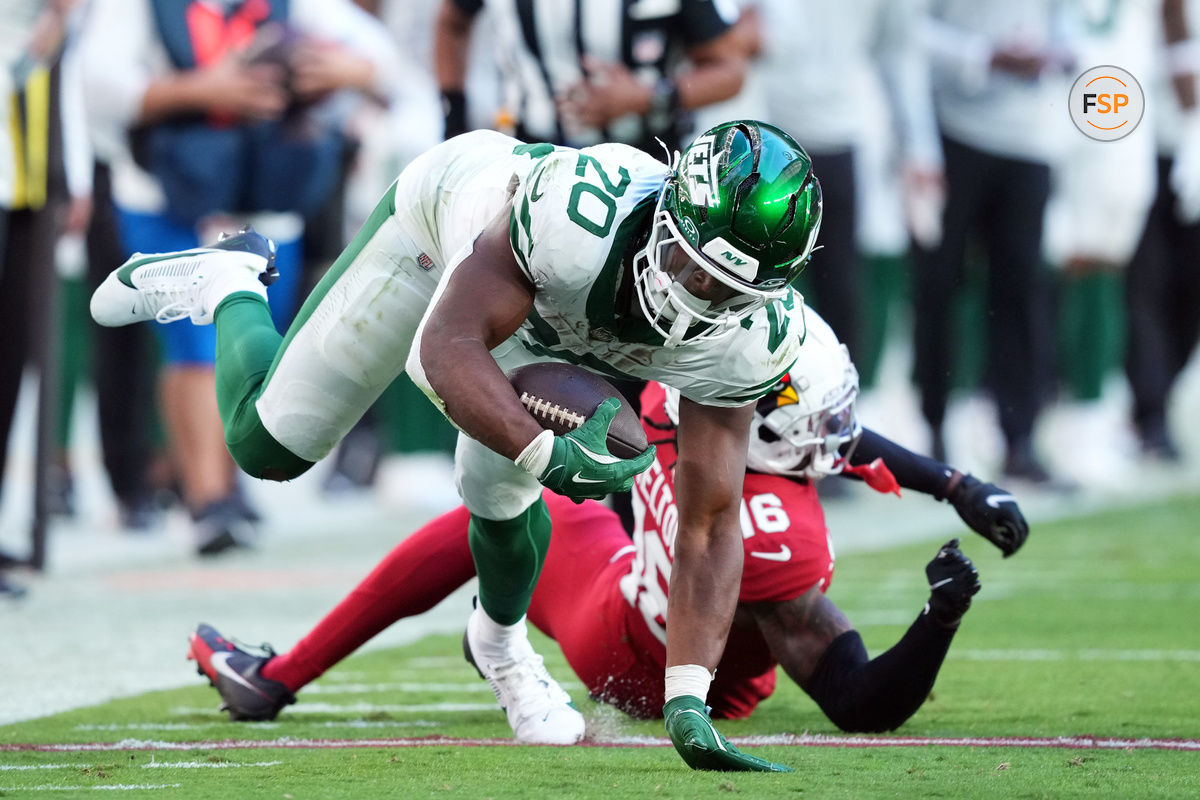 Nov 10, 2024; Glendale, Arizona, USA; New York Jets running back Breece Hall (20) dives past Arizona Cardinals cornerback Max Melton (16) during the second half at State Farm Stadium. Credit: Joe Camporeale-Imagn Images