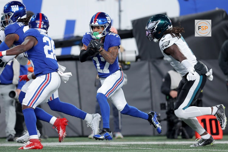 Oct 9, 2025; East Rutherford, New Jersey, USA; New York Giants wide receiver Wan'Dale Robinson (17) runs with the ball for a touchdown against Philadelphia Eagles cornerback Kelee Ringo (7) during the first quarter at MetLife Stadium. Credit: Brad Penner-Imagn Images
