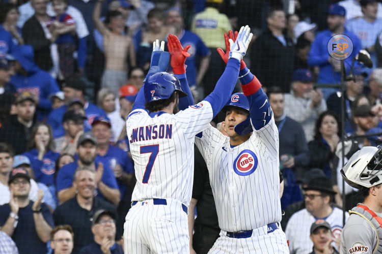 May 6, 2025; Chicago, Illinois, USA;  Chicago Cubs catcher Miguel Amaya (9) high fives Chicago Cubs shortstop Dansby Swanson (7) after they score on his two run home run during the third inning against the San Francisco Giants at Wrigley Field. Credit: Matt Marton-Imagn Images