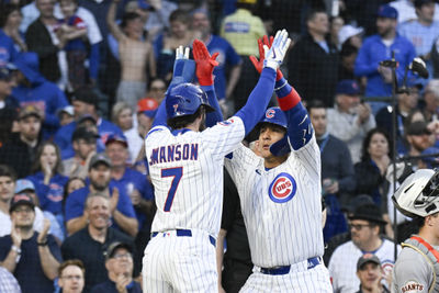 May 6, 2025; Chicago, Illinois, USA;  Chicago Cubs catcher Miguel Amaya (9) high fives Chicago Cubs shortstop Dansby Swanson (7) after they score on his two run home run during the third inning against the San Francisco Giants at Wrigley Field. Mandatory Credit: Matt Marton-Imagn Images